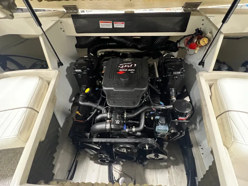 Slide: The Image of Engine compartment of a 2008 Sea Ray 230 Select boat, showcasing the powerful engine setup. - 17