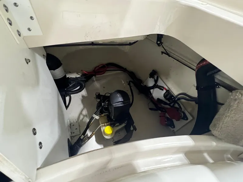 Slide: The Image of Engine compartment of 2008 Sea Ray 230 Select boat, showing mechanical components and wiring. - 19