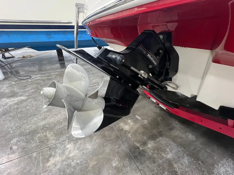 Slide: The Image of 2008 Sea Ray 230 Select boat with stainless steel propeller and red hull detail. - 21