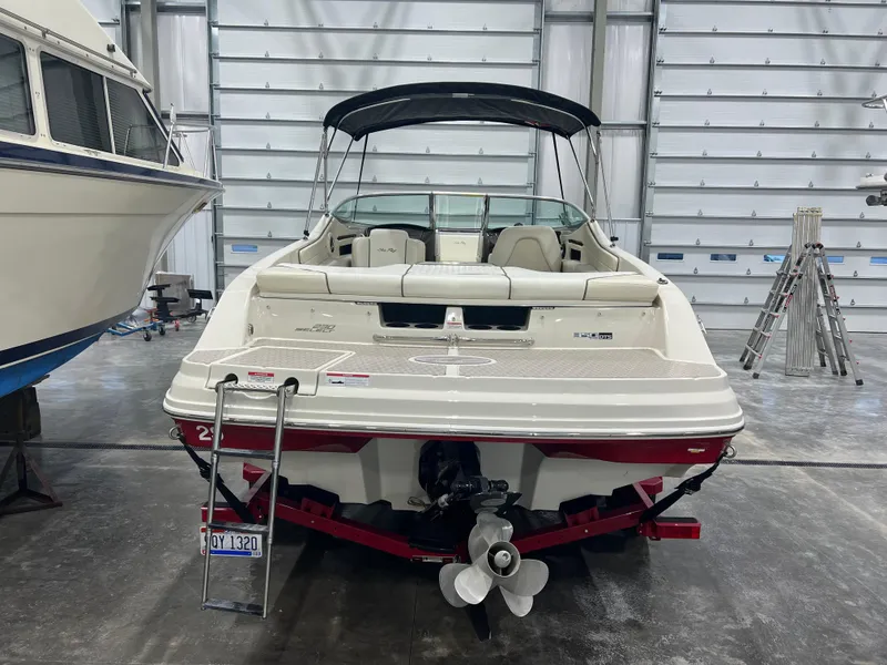 Slide: The Image of 2008 Sea Ray 230 Select boat in storage, rear view with ladder and propeller. - 3