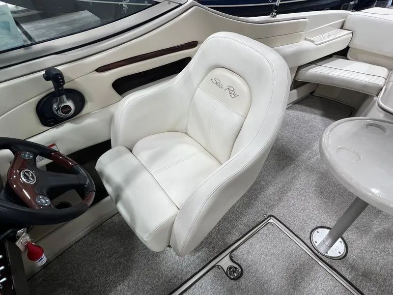 Slide: The Image of 2008 Sea Ray 230 Select boat interior with white leather seating and steering wheel. - 8
