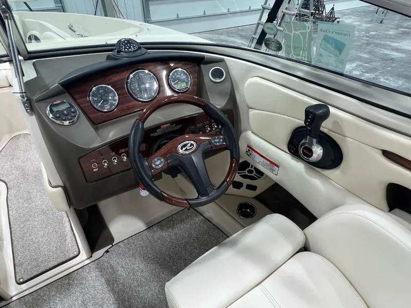 Slide: The Image of 2008 Sea Ray 230 Select boat dashboard with steering wheel and control panel. - 9