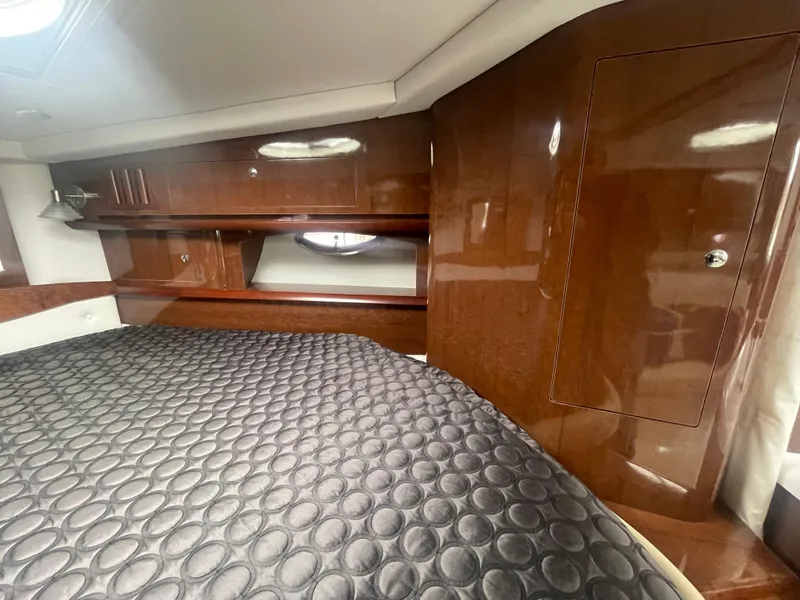 Slide: The Image of Luxurious cabin interior of 2014 Four Winns Vista 375 yacht with wood paneling and cozy bedding. - 12