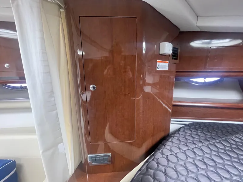 Slide: The Image of 2014 Four Winns Vista 375 cabin interior with wood paneling and bed. - 13