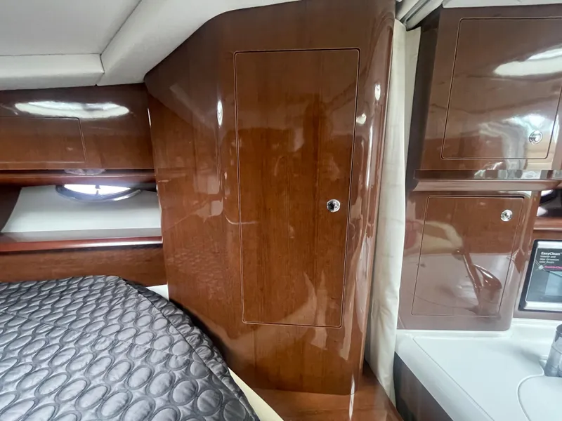 Slide: The Image of Interior of 2014 Four Winns Vista 375 boat with wood cabinetry and bed. - 14