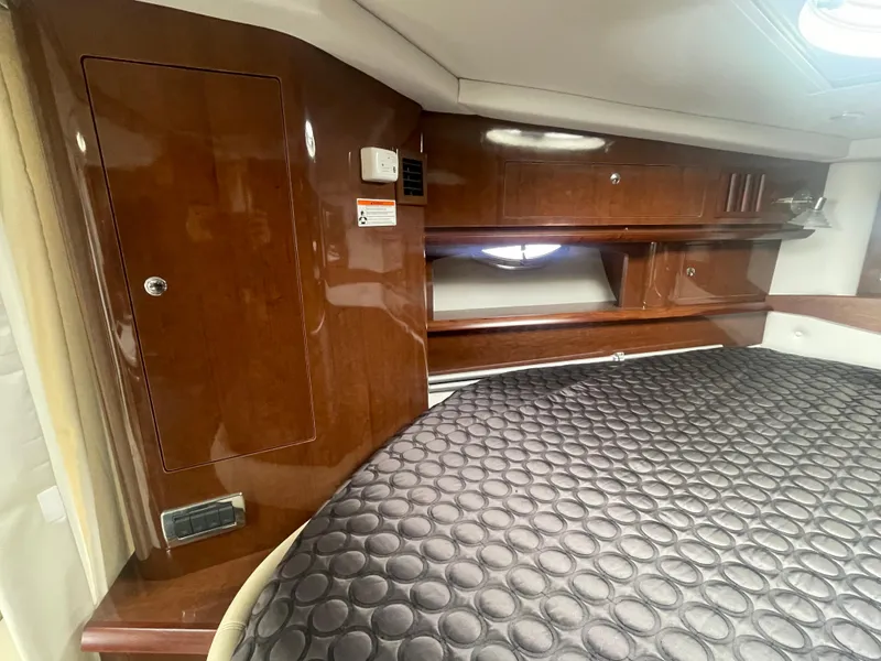 Slide: The Image of Luxurious cabin interior of 2014 Four Winns Vista 375 with wood finish and cozy bedding. - 15