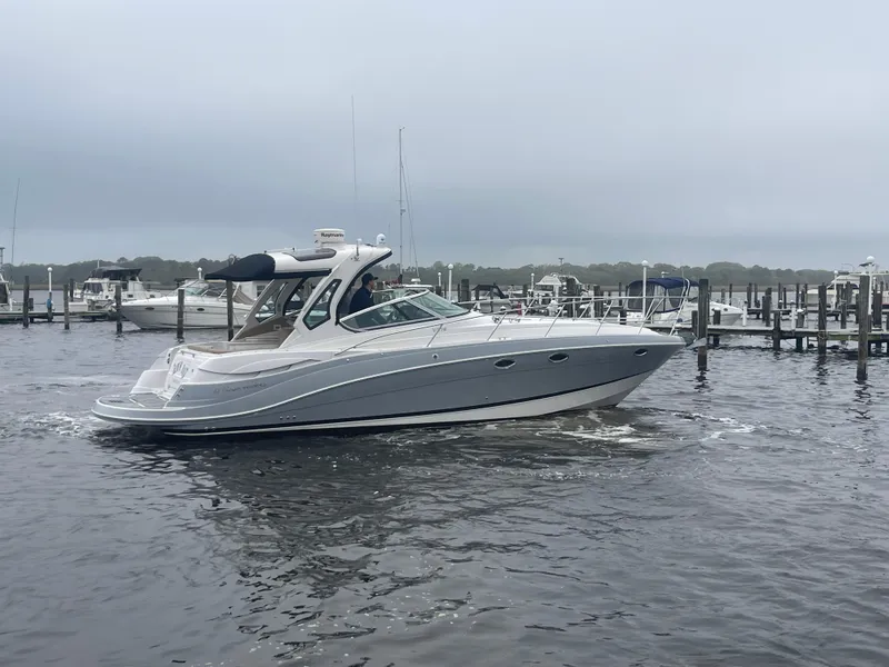 Slide: The Image of 2014 Four Winns Vista 375 boat docked in a marina on a cloudy day. - 2