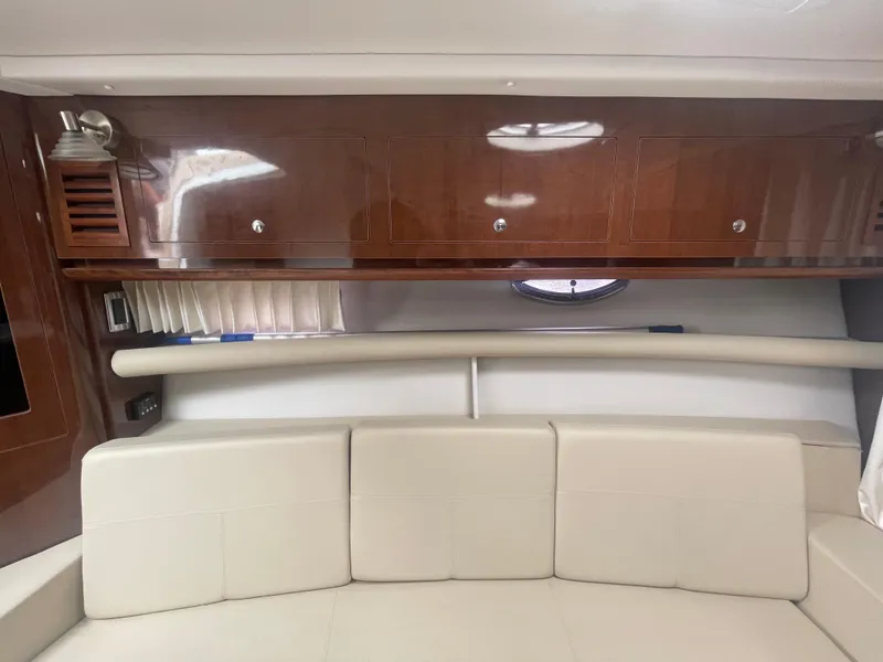 Slide: The Image of Interior of 2014 Four Winns Vista 375 yacht with beige seating and wooden cabinets. - 24
