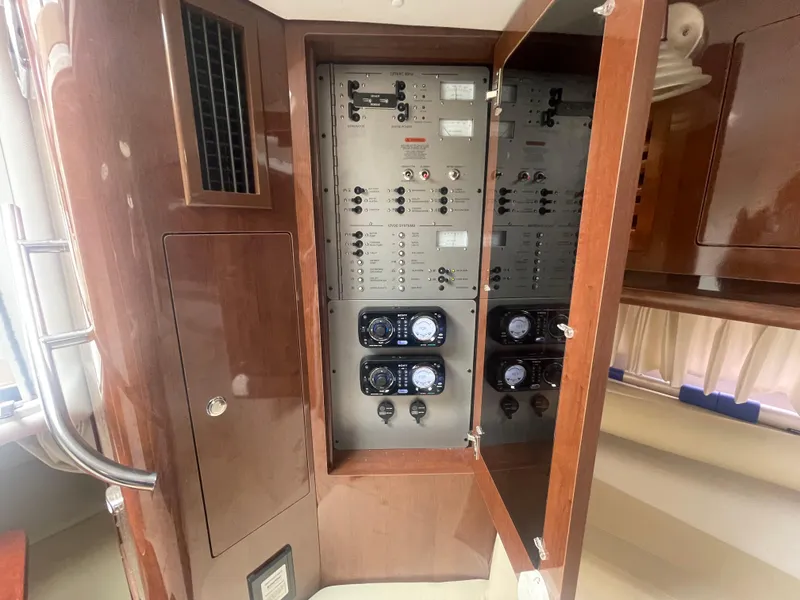 Slide: The Image of Electrical panel inside 2014 Four Winns Vista 375 boat, featuring control switches and gauges. - 26