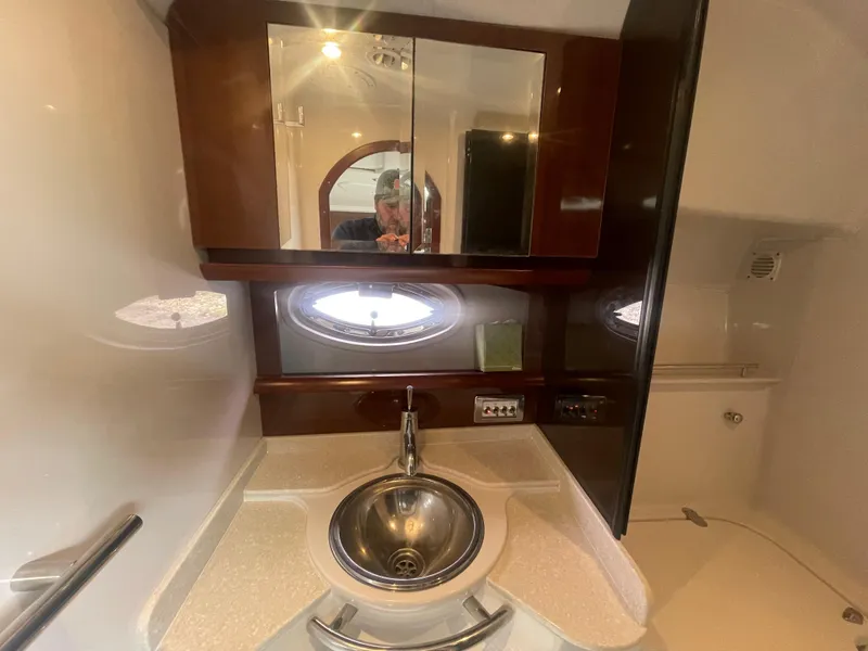 Slide: The Image of 2014 Four Winns Vista 375 bathroom with sink, mirror, and porthole window. - 28