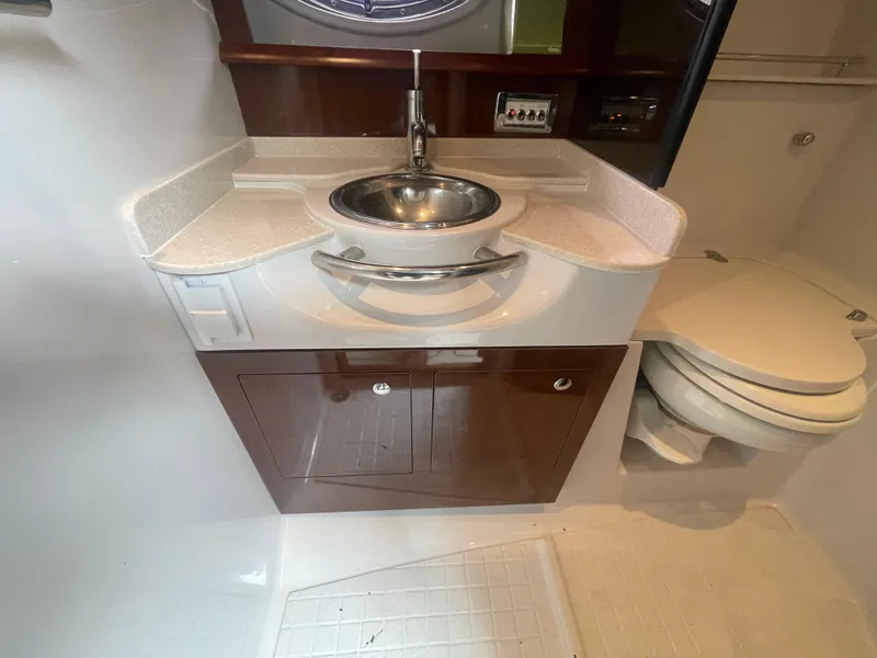 Slide: The Image of 2014 Four Winns Vista 375 bathroom with sink, cabinet, and toilet. - 29