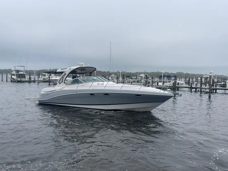 Slide: The Image of 2014 Four Winns Vista 375 yacht docked in a marina on a cloudy day. - 3