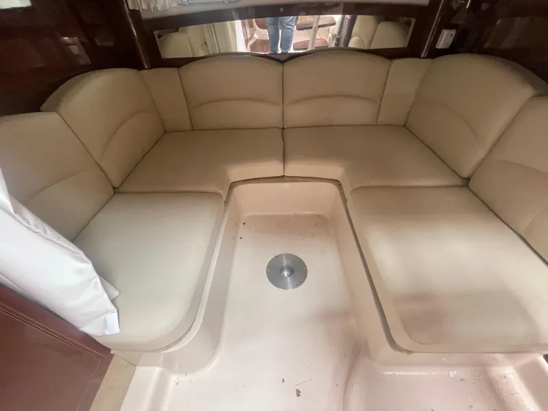 Slide: The Image of 2014 Four Winns Vista 375 interior with beige leather seating in a cozy cabin. - 31