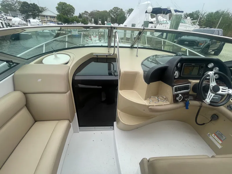 Slide: The Image of 2014 Four Winns Vista 375 boat interior with beige seating and modern dashboard. - 33