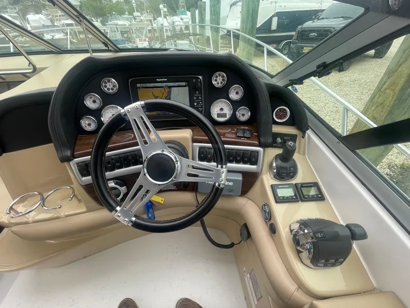 Slide: The Image of Cockpit of 2014 Four Winns Vista 375 boat with steering wheel and navigation controls. - 36