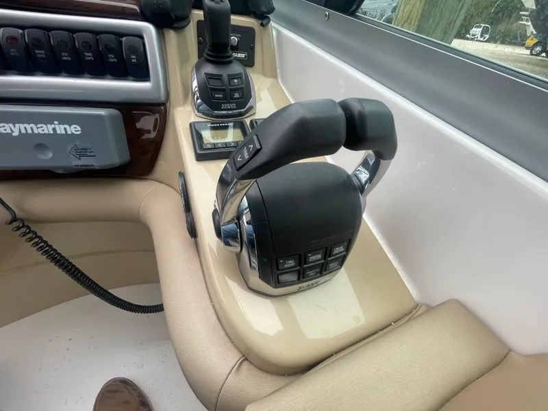 Slide: The Image of Control panel of a 2014 Four Winns Vista 375 boat with throttle levers and navigation equipment. - 42