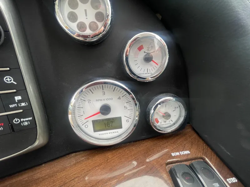 Slide: The Image of Dashboard gauges of a 2014 Four Winns Vista 375 boat, featuring RPM and fuel indicators. - 44