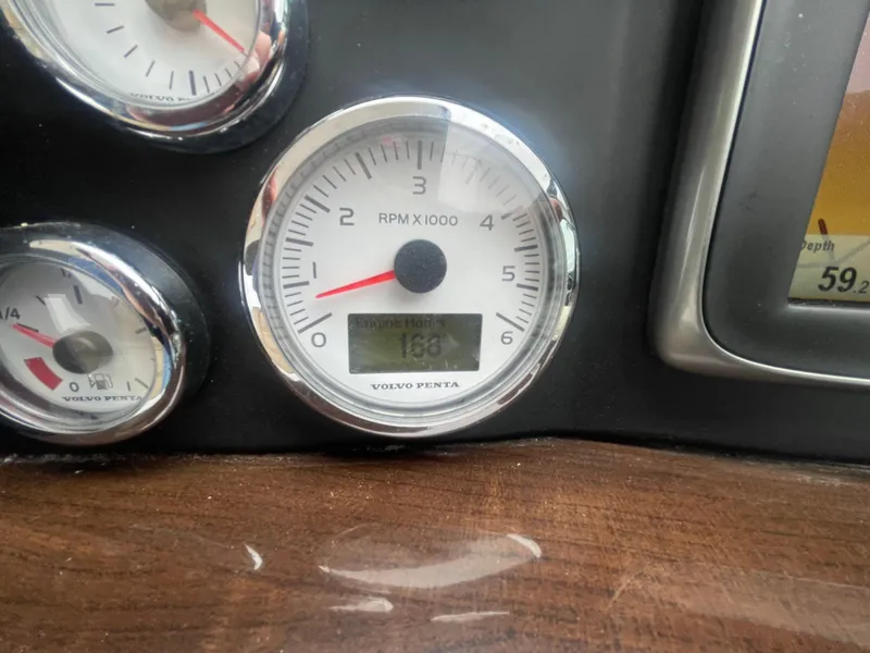 Slide: The Image of Close-up of a 2014 Four Winns Vista 375 boat's RPM gauge, displaying engine hours. - 46