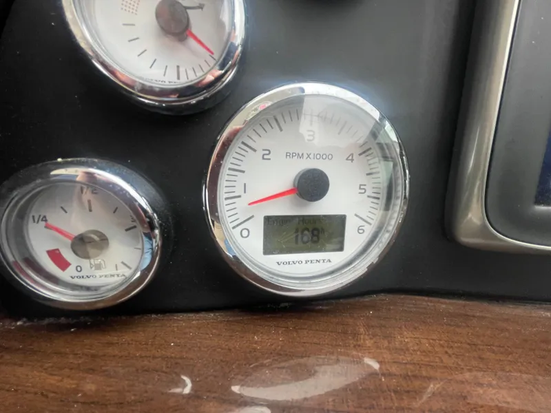 Slide: The Image of Close-up of Four Winns Vista 375 2014 boat dashboard gauges, showing RPM and fuel levels. - 47