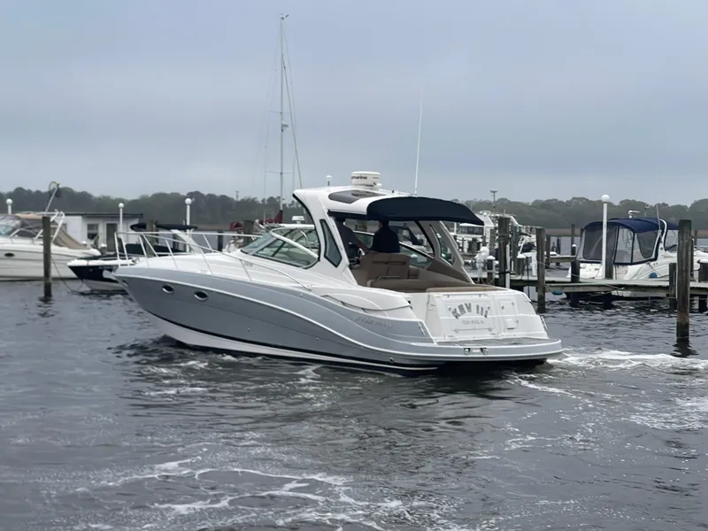 Slide: The Image of 2014 Four Winns Vista 375 boat docked in a marina, overcast sky. - 5