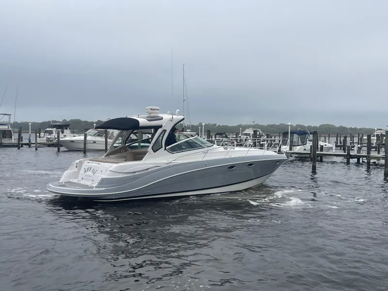 Slide: The Image of 2014 Four Winns Vista 375 boat cruising in a marina under cloudy skies. - 6