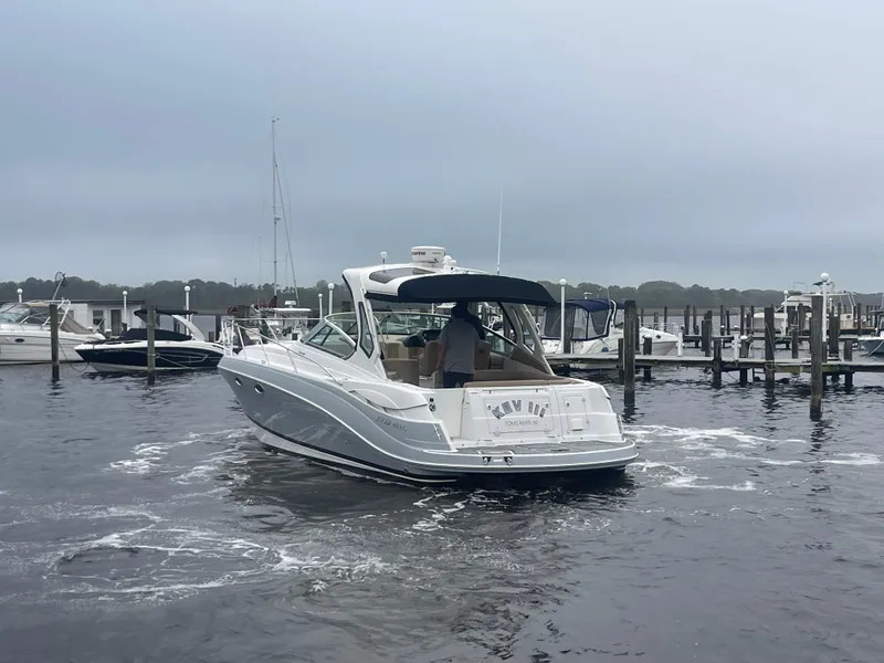 Slide: The Image of 2014 Four Winns Vista 375 boat docked in a marina on a cloudy day. - 8