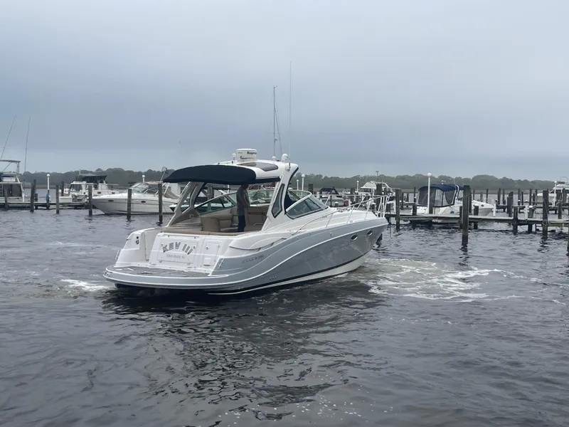 Slide: The Image of 2014 Four Winns Vista 375 boat docked in a marina on a cloudy day. - 9
