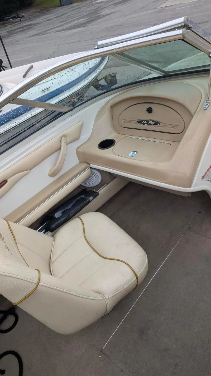 Slide: The Image of 2001 Sea Ray 185 Sport Boat interior with beige seating and dashboard. - 12