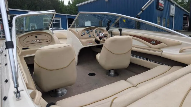 Slide: The Image of 2001 Sea Ray 185 Sport Boat interior with beige seating and dashboard. - 5