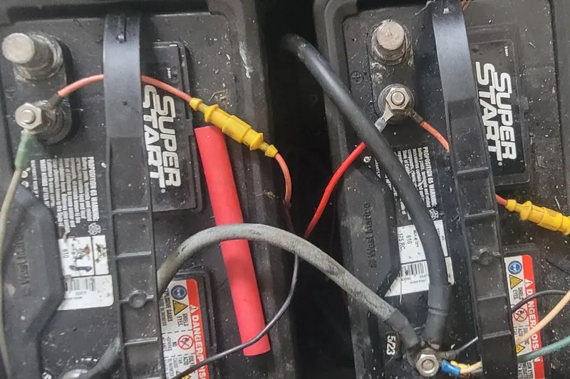 Slide: The Image of Two Super Start batteries with connected cables in a 1985 SISU Softtop Cruiser. - 15