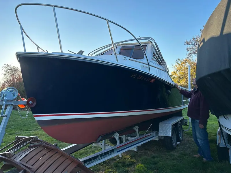 Slide: The Image of 1985 SISU Softtop Cruiser on trailer, parked outdoors under clear sky. - 19