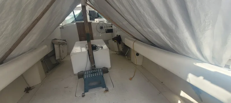 Slide: The Image of 1985 SISU Softtop Cruiser interior with covered seating and helm area. - 4