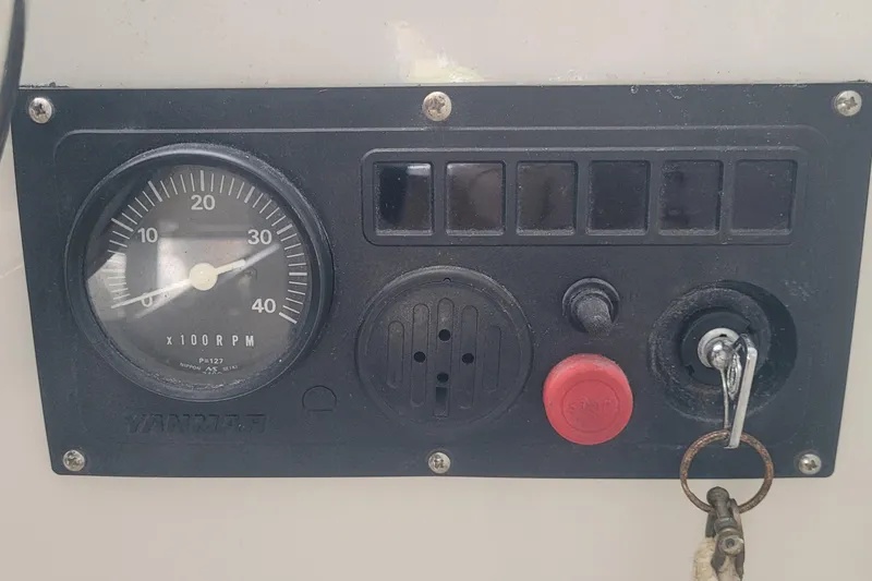 Slide: The Image of Control panel of a 1985 SISU Softtop Cruiser with RPM gauge and ignition key. - 9