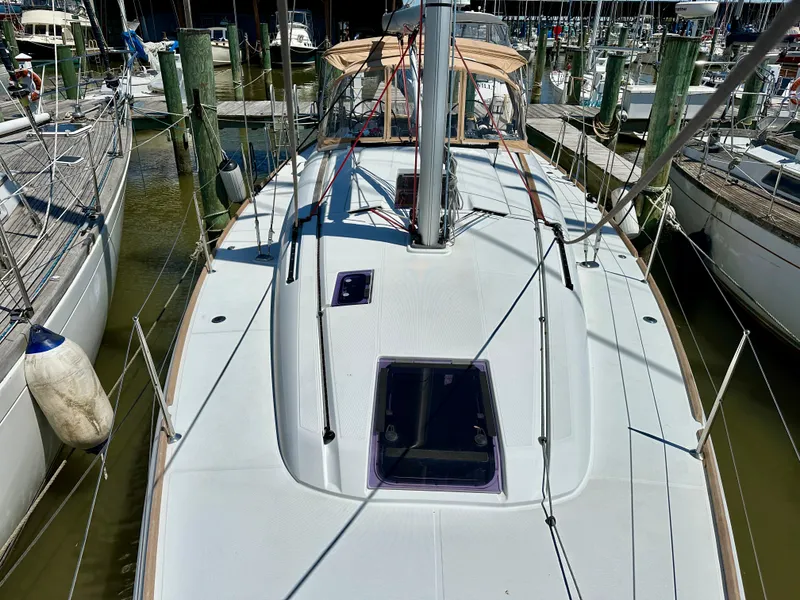 Slide: The Image of 2018 Jeanneau Sun Odyssey 419 sailboat docked at marina, showcasing deck and rigging. - 23