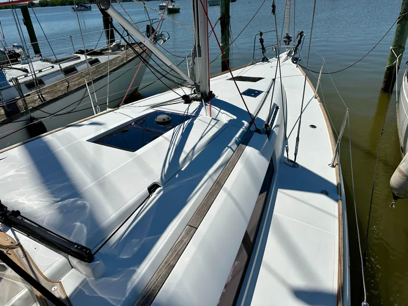 Slide: The Image of 2018 Jeanneau Sun Odyssey 419 sailboat docked, showcasing sleek deck design and rigging. - 24
