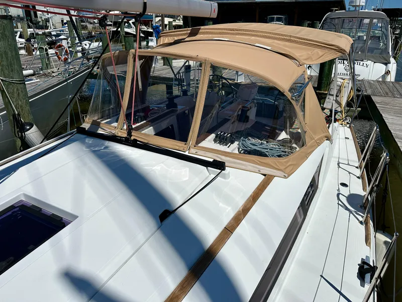 Slide: The Image of 2018 Jeanneau Sun Odyssey 419 sailboat with tan canopy docked at marina. - 25