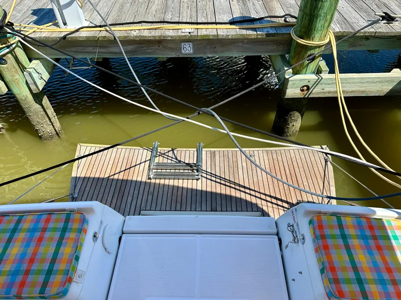 Slide: The Image of Jeanneau Sun Odyssey 419, 2018, docked with colorful seating, wooden pier, and mooring lines. - 26