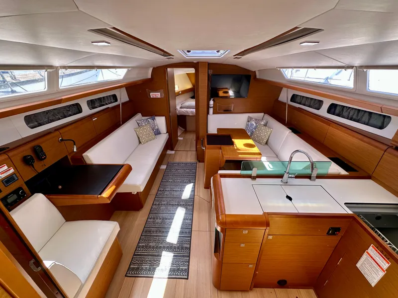Slide: The Image of 2018 Jeanneau Sun Odyssey 419 interior with modern design, spacious seating, and elegant wood finishes. - 27