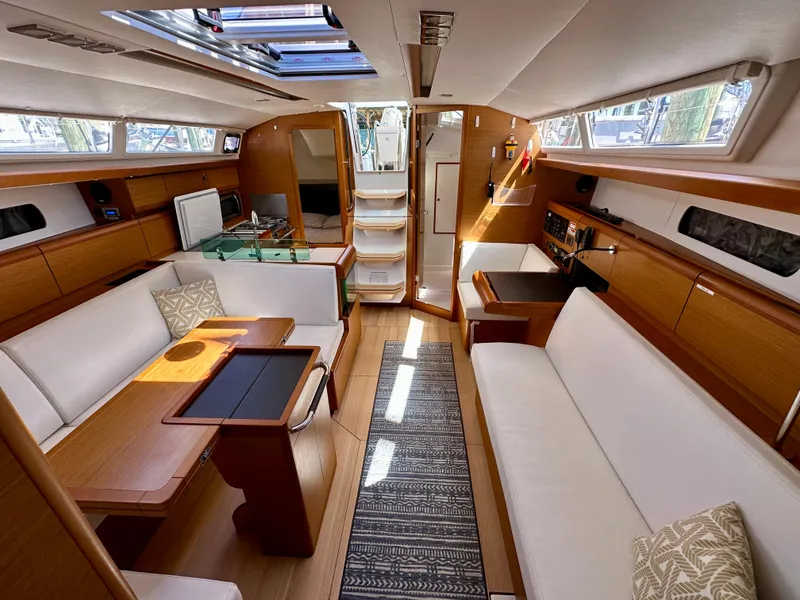 Slide: The Image of 2018 Jeanneau Sun Odyssey 419 interior with elegant wood finish and spacious seating. - 28