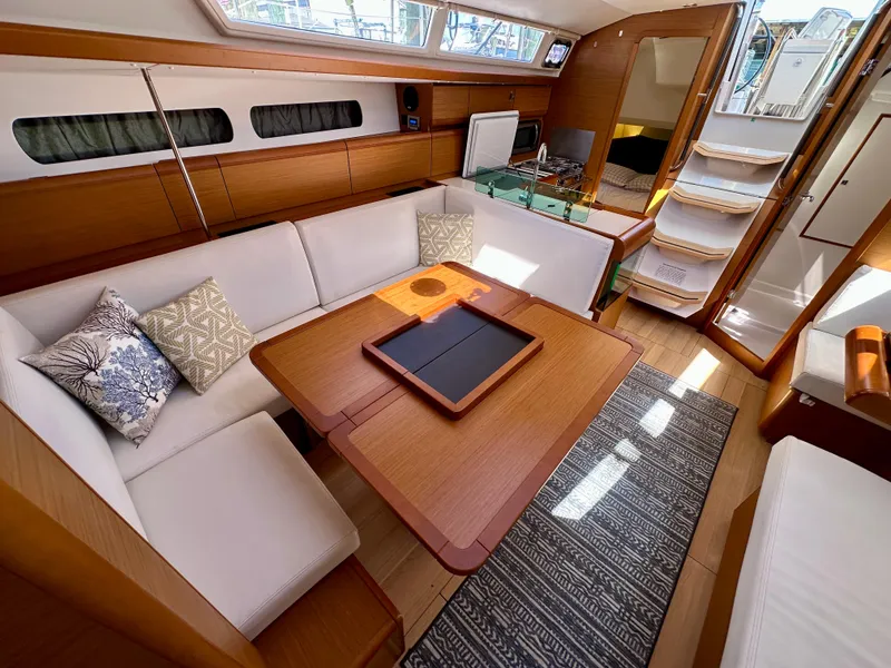 Slide: The Image of Interior of 2018 Jeanneau Sun Odyssey 419 yacht with elegant seating and wooden finishes. - 29