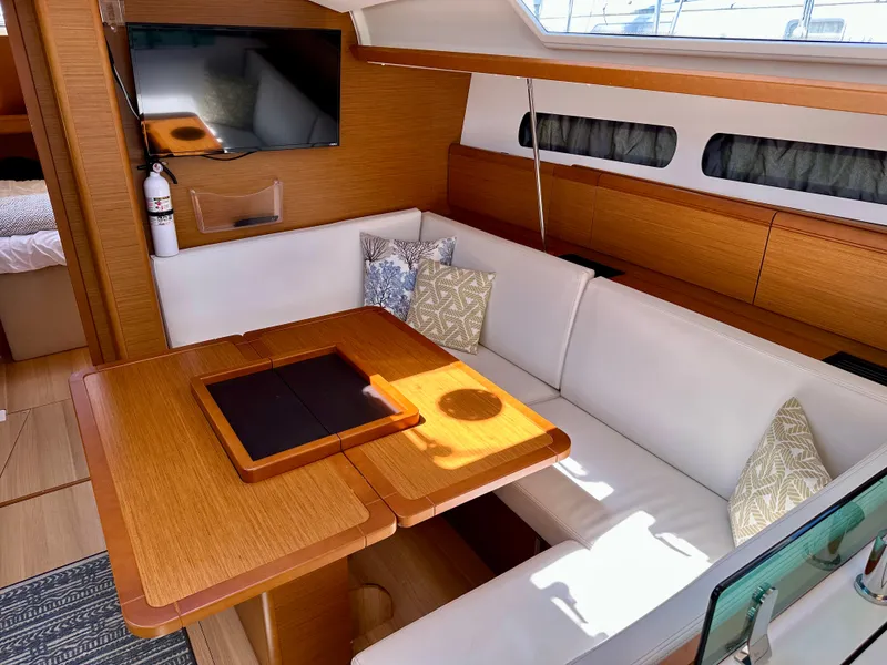 Slide: The Image of 2018 Jeanneau Sun Odyssey 419 interior with cozy seating and wooden dining table. - 30