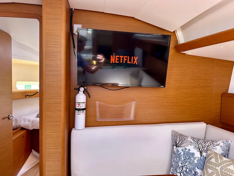 Slide: The Image of Interior of 2018 Jeanneau Sun Odyssey 419 yacht with TV displaying Netflix. - 35
