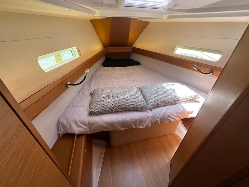Slide: The Image of 2018 Jeanneau Sun Odyssey 419 cabin interior with cozy bed and natural light. - 38