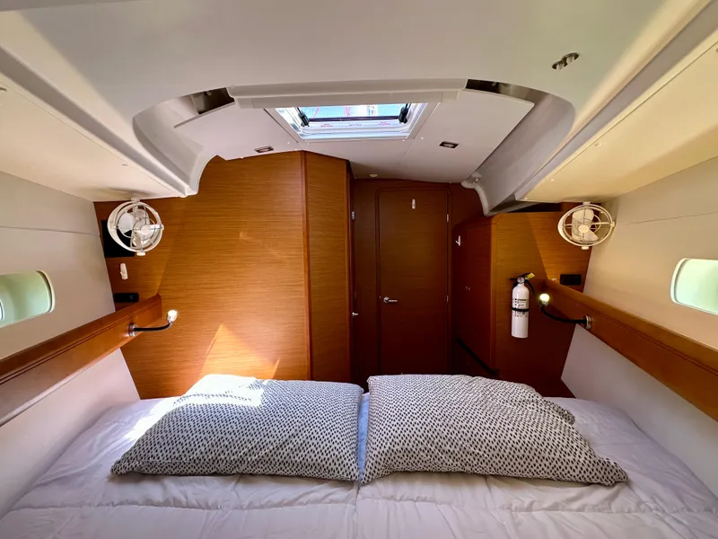 Slide: The Image of 2018 Jeanneau Sun Odyssey 419 cabin interior with skylight and cozy bedding. - 39