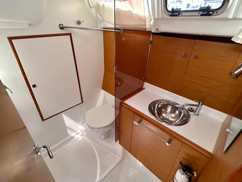 Slide: The Image of 2018 Jeanneau Sun Odyssey 419 bathroom with modern fixtures and wooden cabinetry. - 40