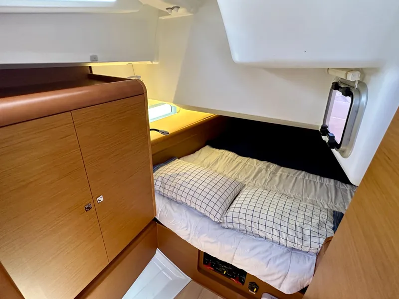 Slide: The Image of Cozy cabin interior of 2018 Jeanneau Sun Odyssey 419 sailboat with bed and storage. - 43