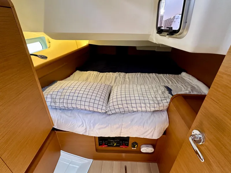 Slide: The Image of Cozy cabin interior of 2018 Jeanneau Sun Odyssey 419 sailboat with bed and window. - 44