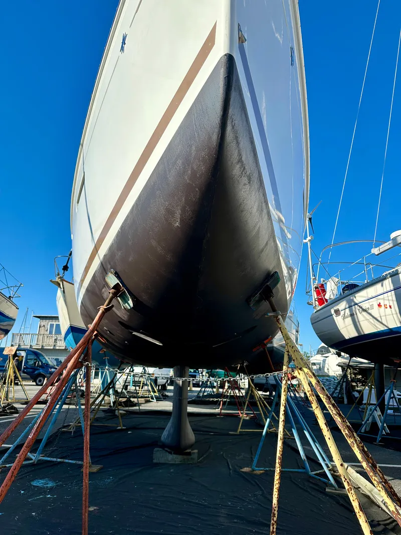 Slide: The Image of 2018 Jeanneau Sun Odyssey 419 sailboat in dry dock, viewed from the bow. - 48