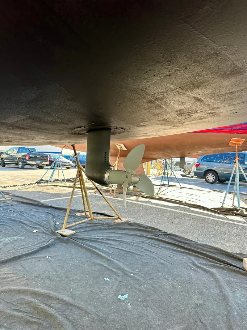 Slide: The Image of 2018 Jeanneau Sun Odyssey 419 sailboat propeller and hull in dry dock. - 49