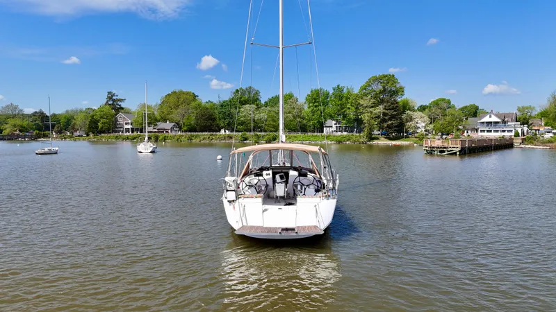 Slide: The Image of 2018 Jeanneau Sun Odyssey 419 sailboat on calm water near a scenic shoreline. - 5